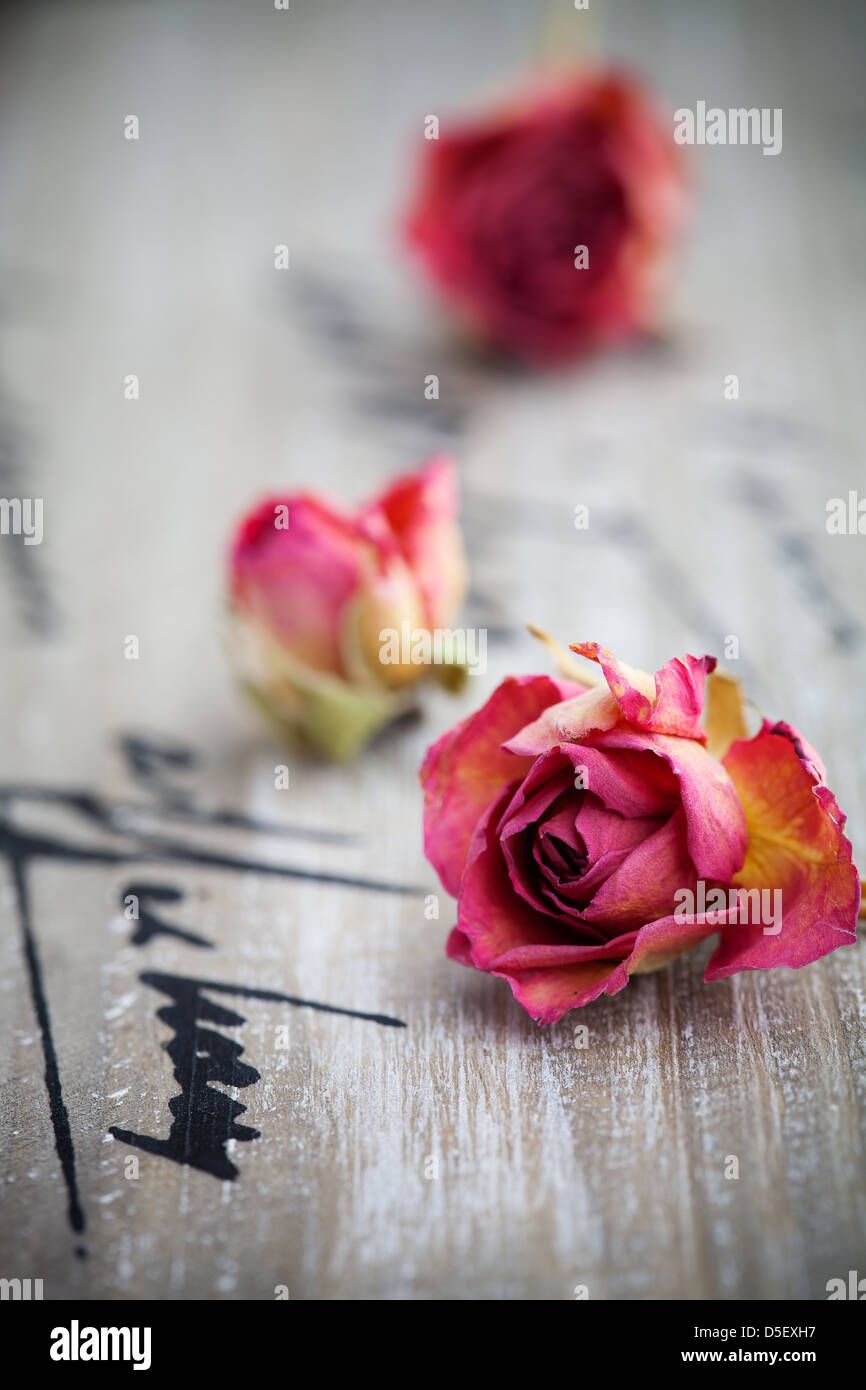 Beautiful dried pink roses on wooden background Stock Photo - Alamy