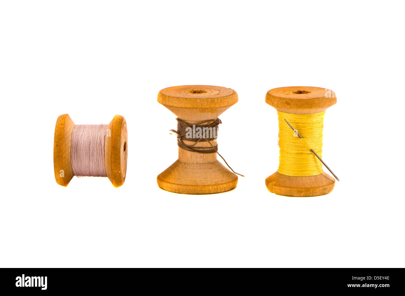 three old thread spools on isolated white background Stock Photo