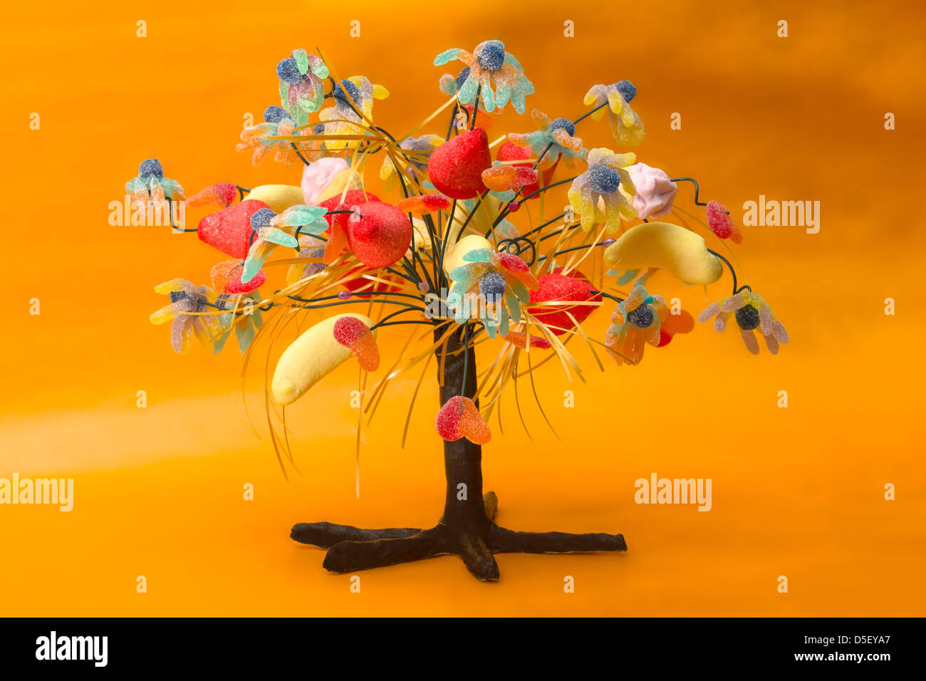 Candy tree on orange background Stock Photo - Alamy