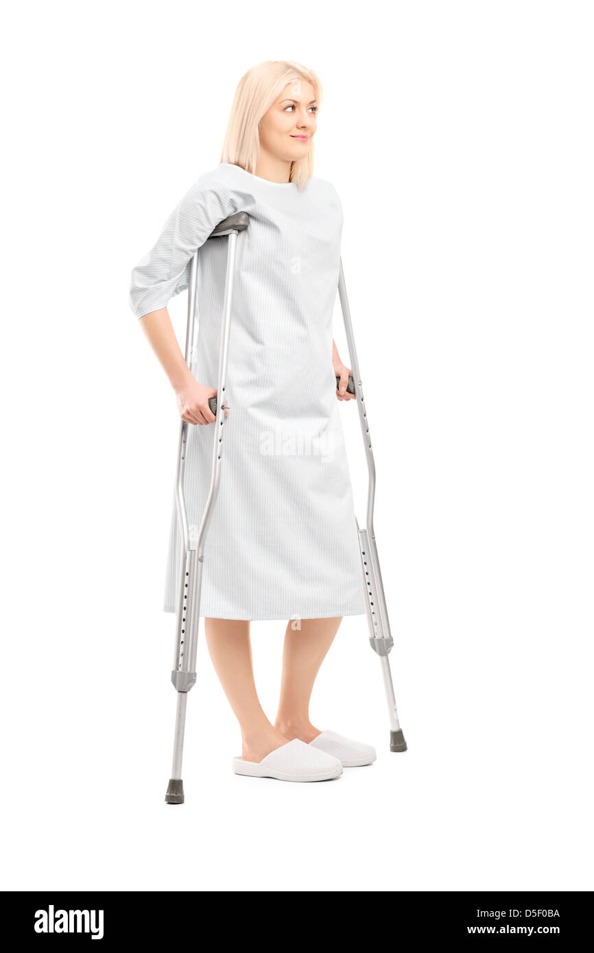 Full length portrait of a blond female patient in hospital gown with ...
