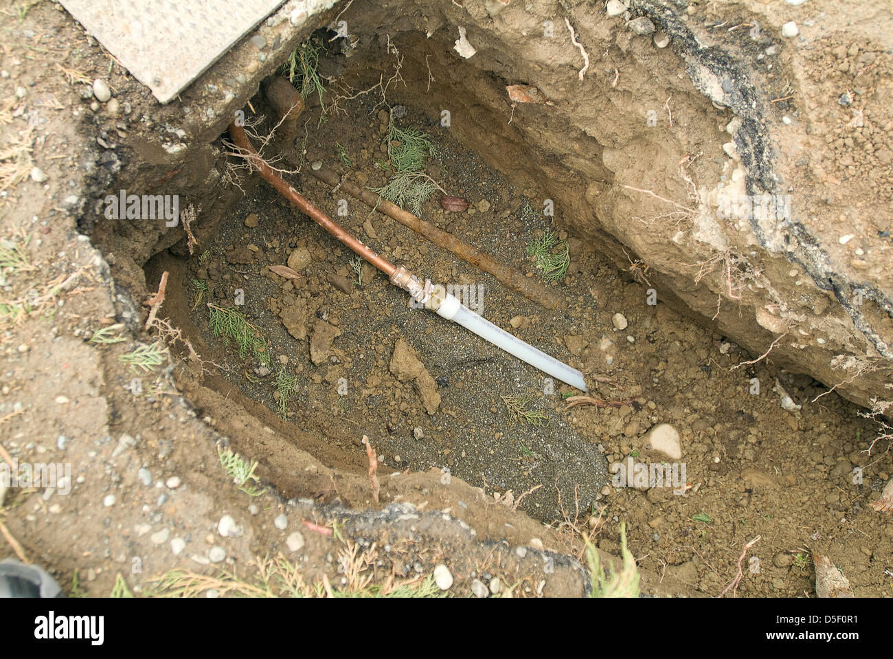 New main water line made from plastic next to old copper water main