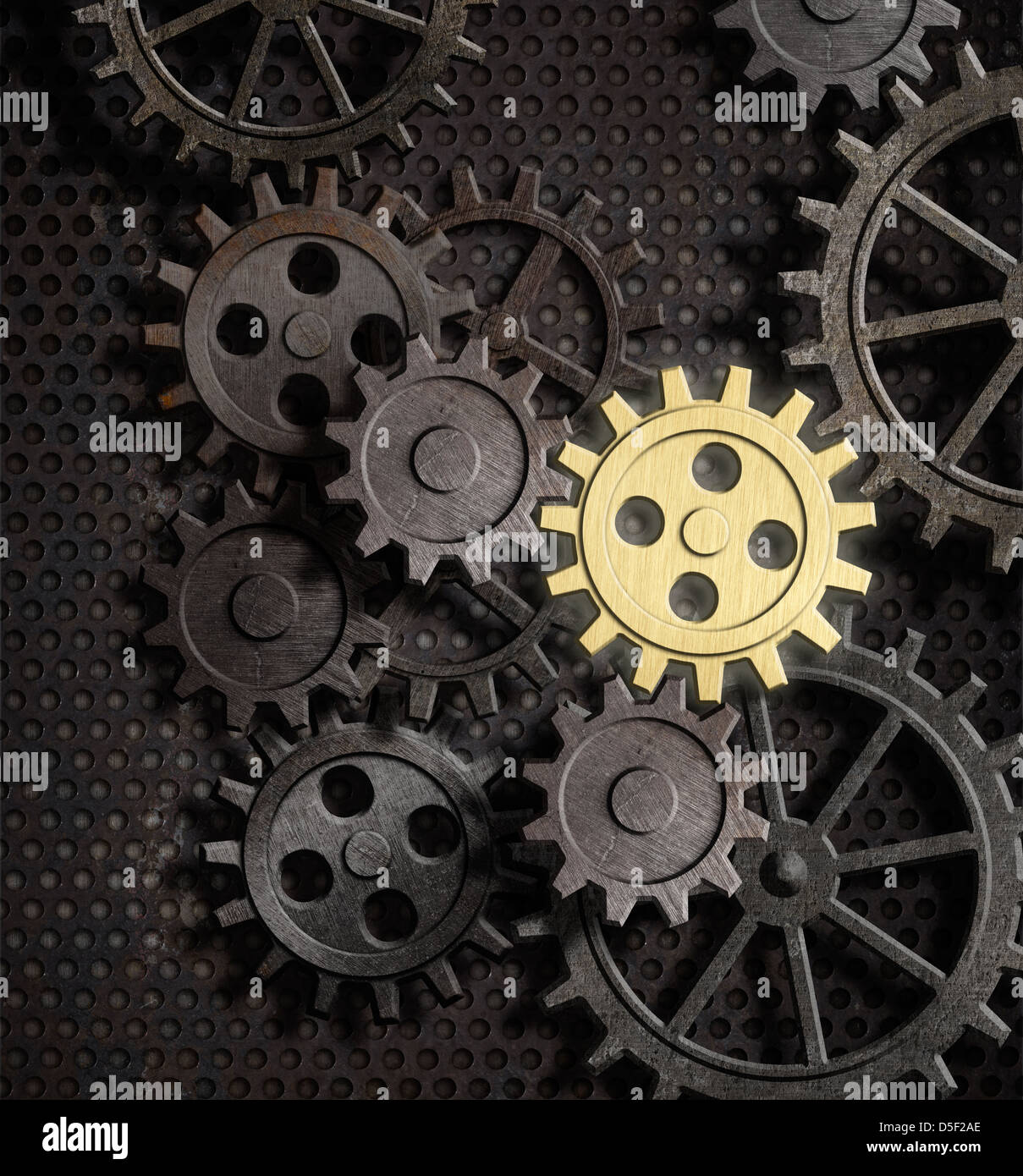 rusty gears and cogs with gold one Stock Photo