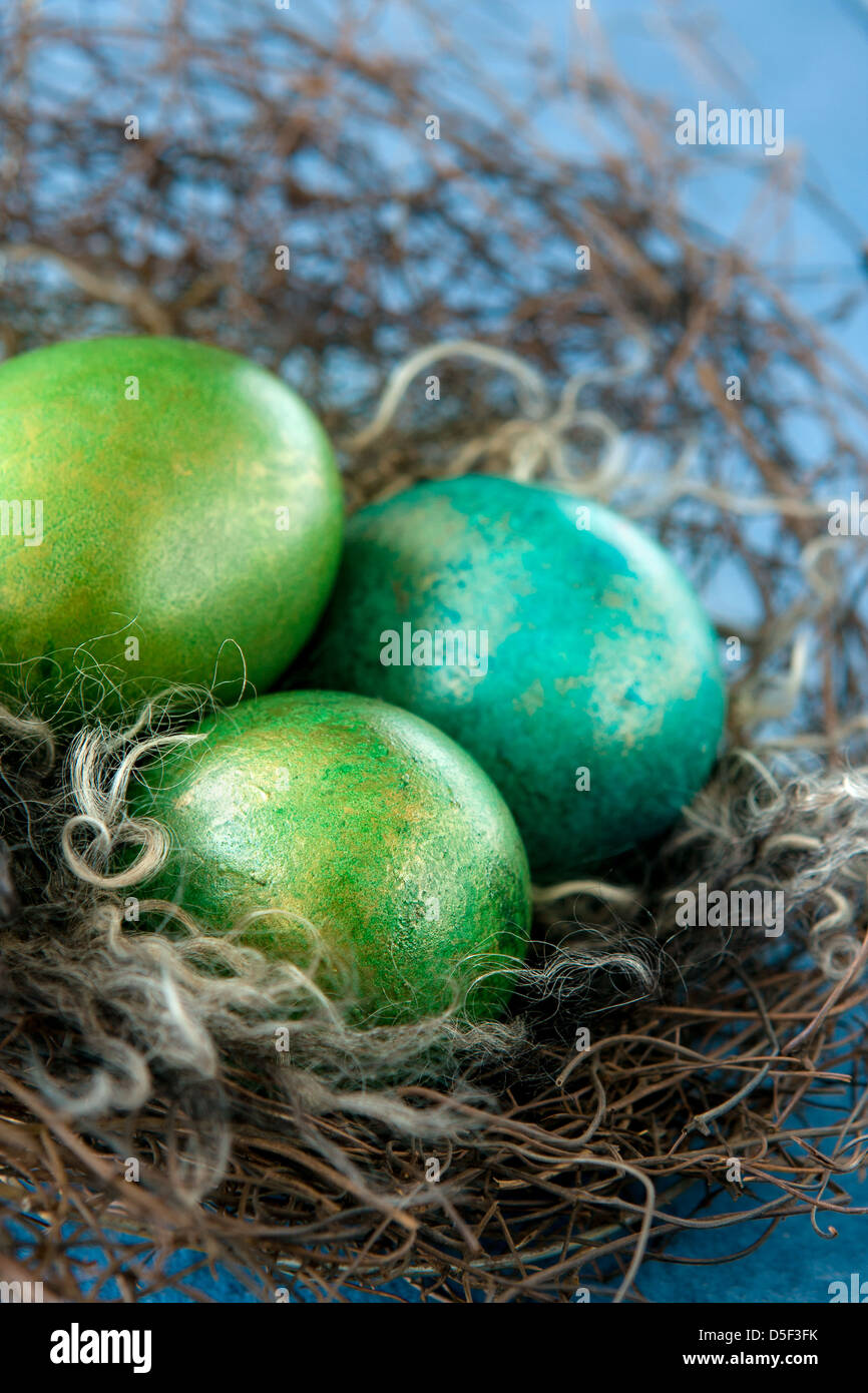 Easter colorful eggs in nest on blue background Stock Photo - Alamy