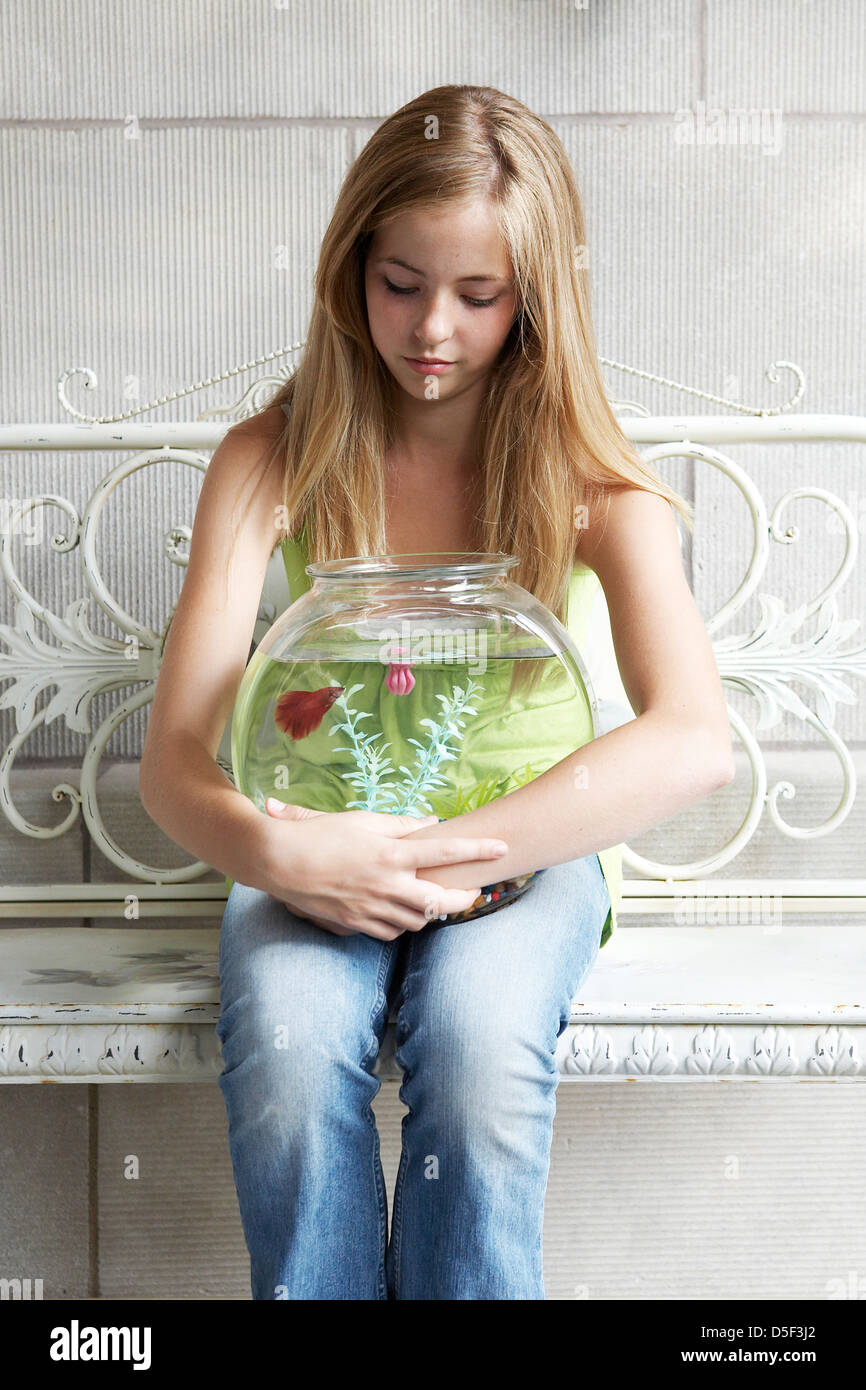 14 year old girl holding fish bowl Stock Photo