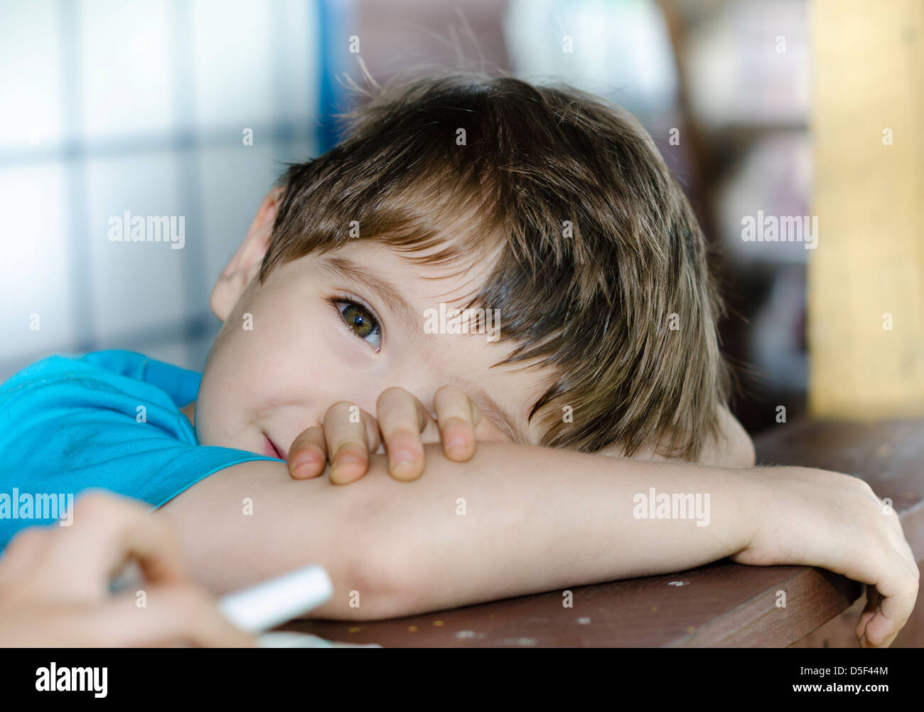 A wistful child on his porch Stock Photo
