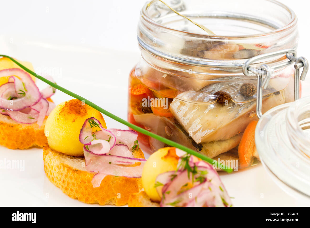 pickled herring in a glass jar with potato canapes Stock Photo Alamy