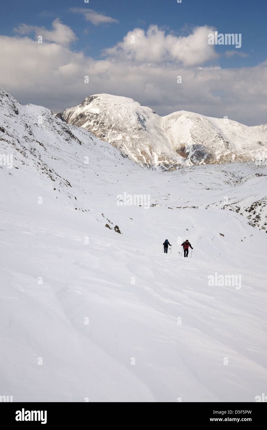 Walkers approaching Esk Hause, with Great Gable and Green Gable in the background, winter in the English Lake District Stock Photo