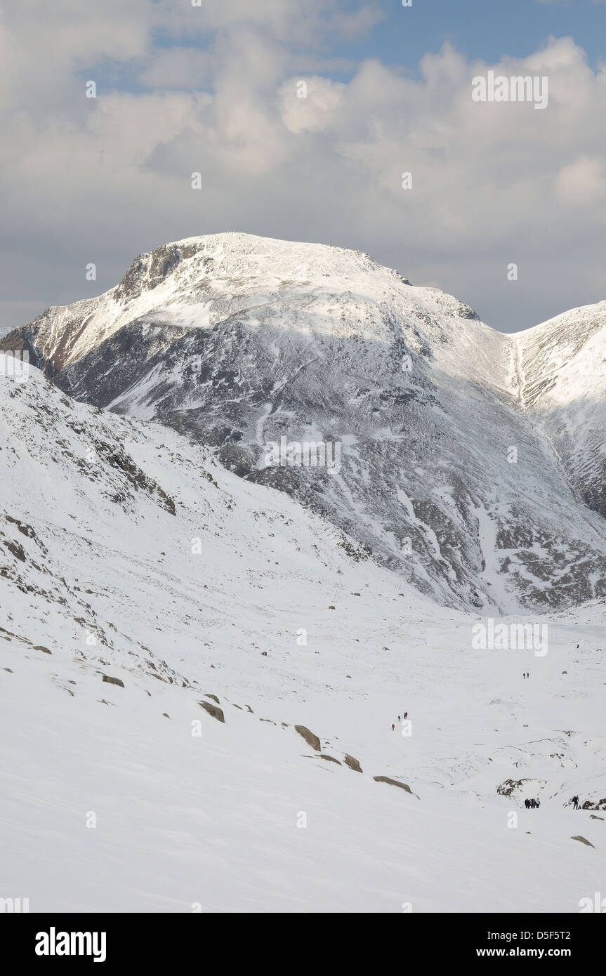 Portrait view of Great Gable from Esk Hause, English lake District. Walkers in foreground for scale Stock Photo