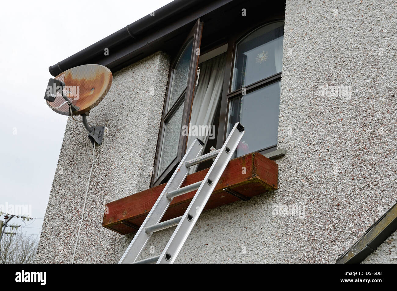 a ladder at an open window Stock Photo
