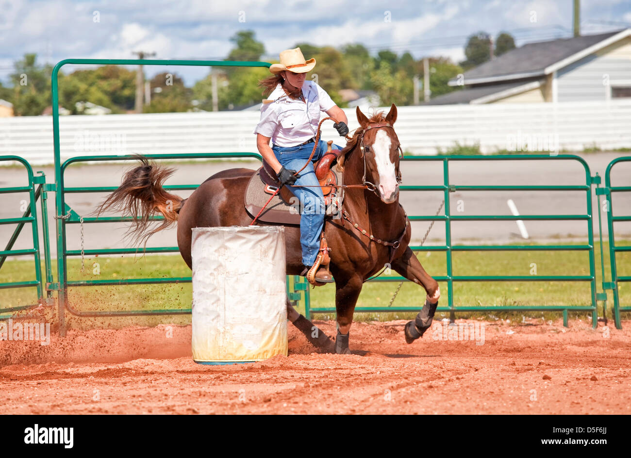 Western horse and rider competing in pole bending and barrel racing competition. Stock Photo