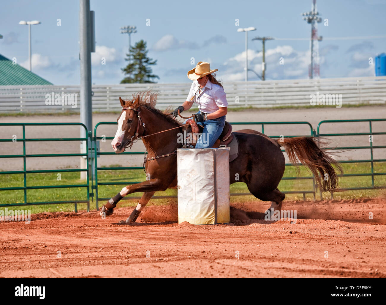 Western horse and rider competing in pole bending and barrel racing competition. Stock Photo