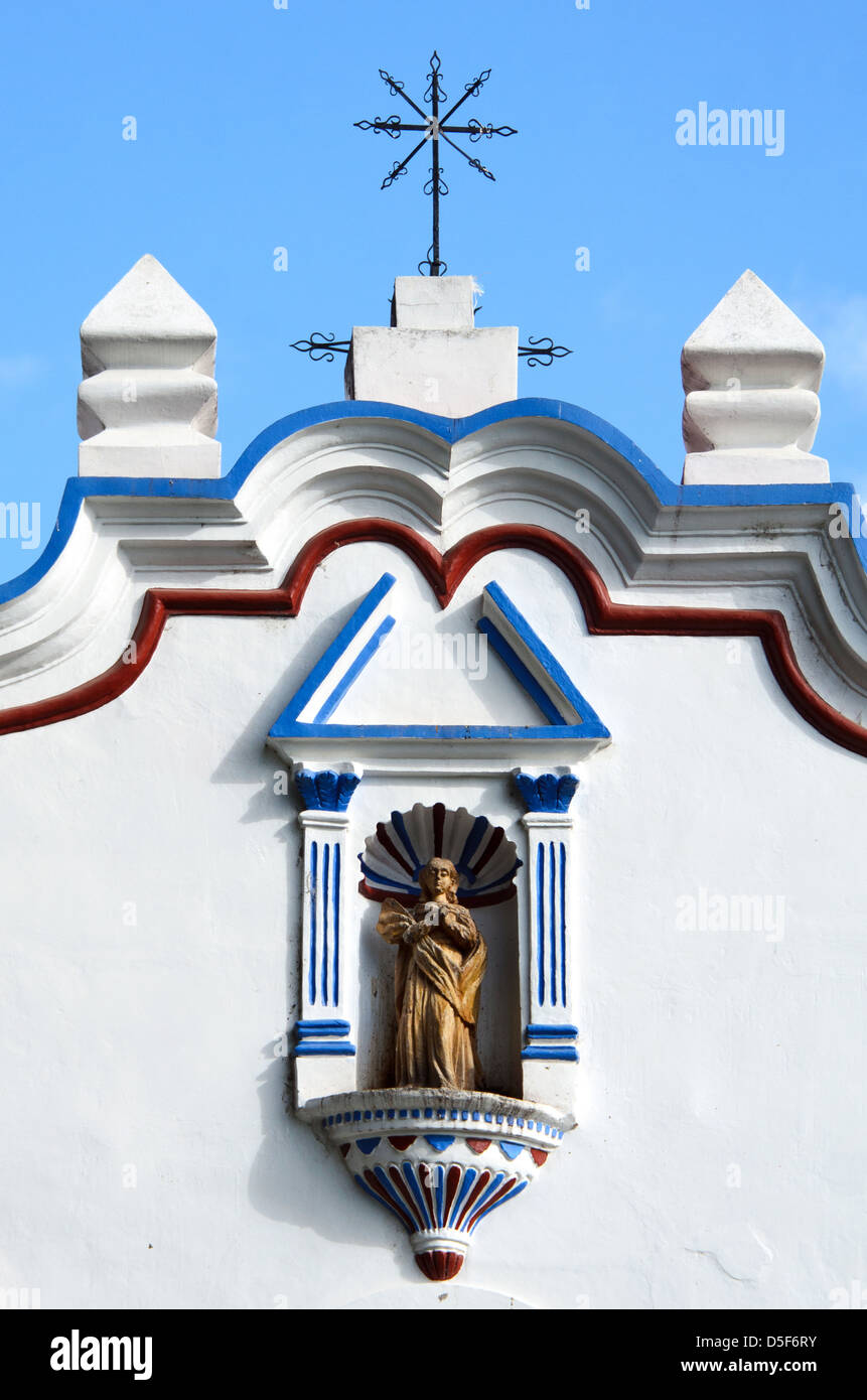 A statue of the Virgin Mary in a niche on the facade of Santa Maria de la Asuncion in Tule, Mexico. Stock Photo