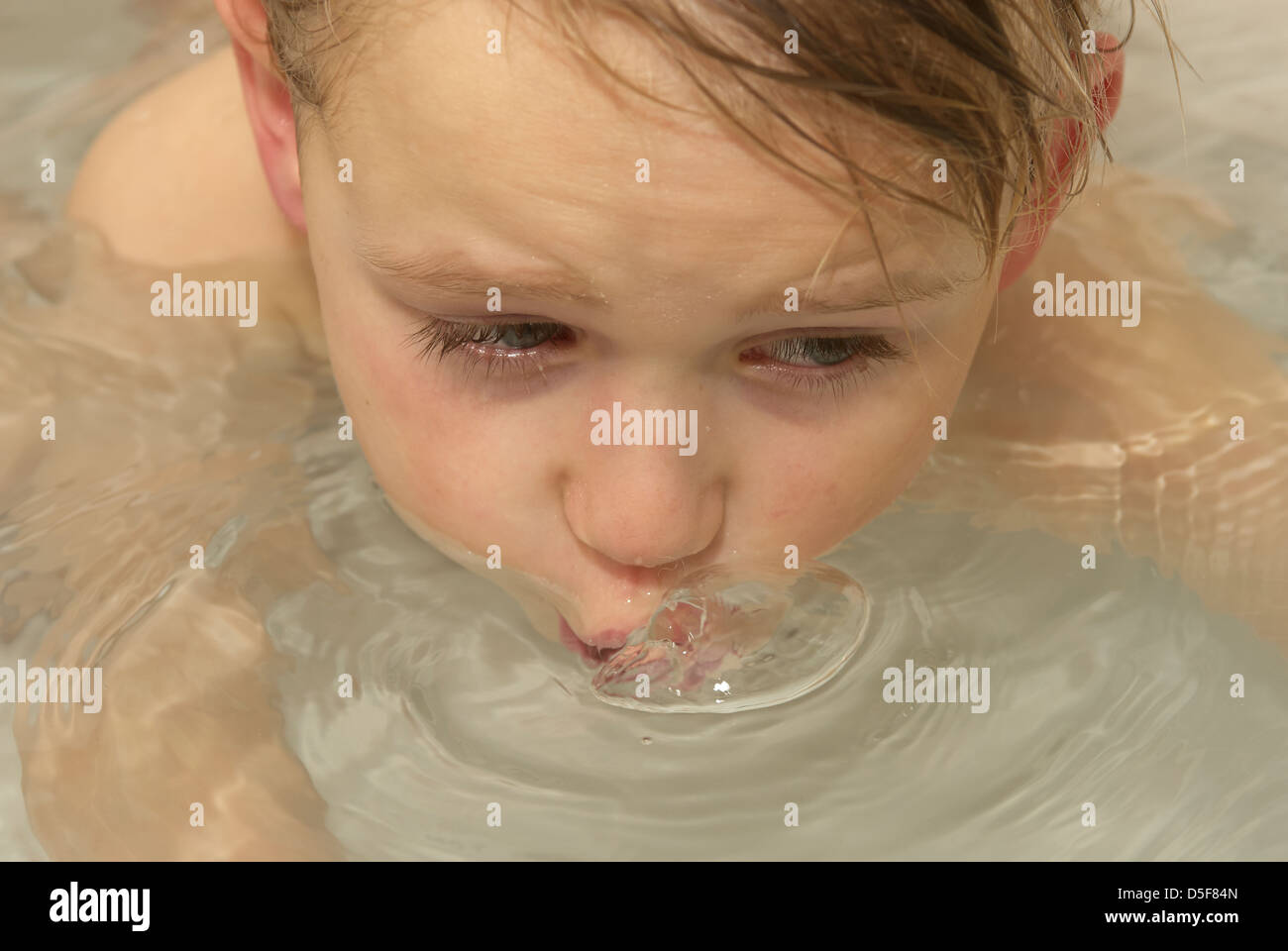 LittleChild Blond Boy Floating in Bathtub Stock Photo Alamy