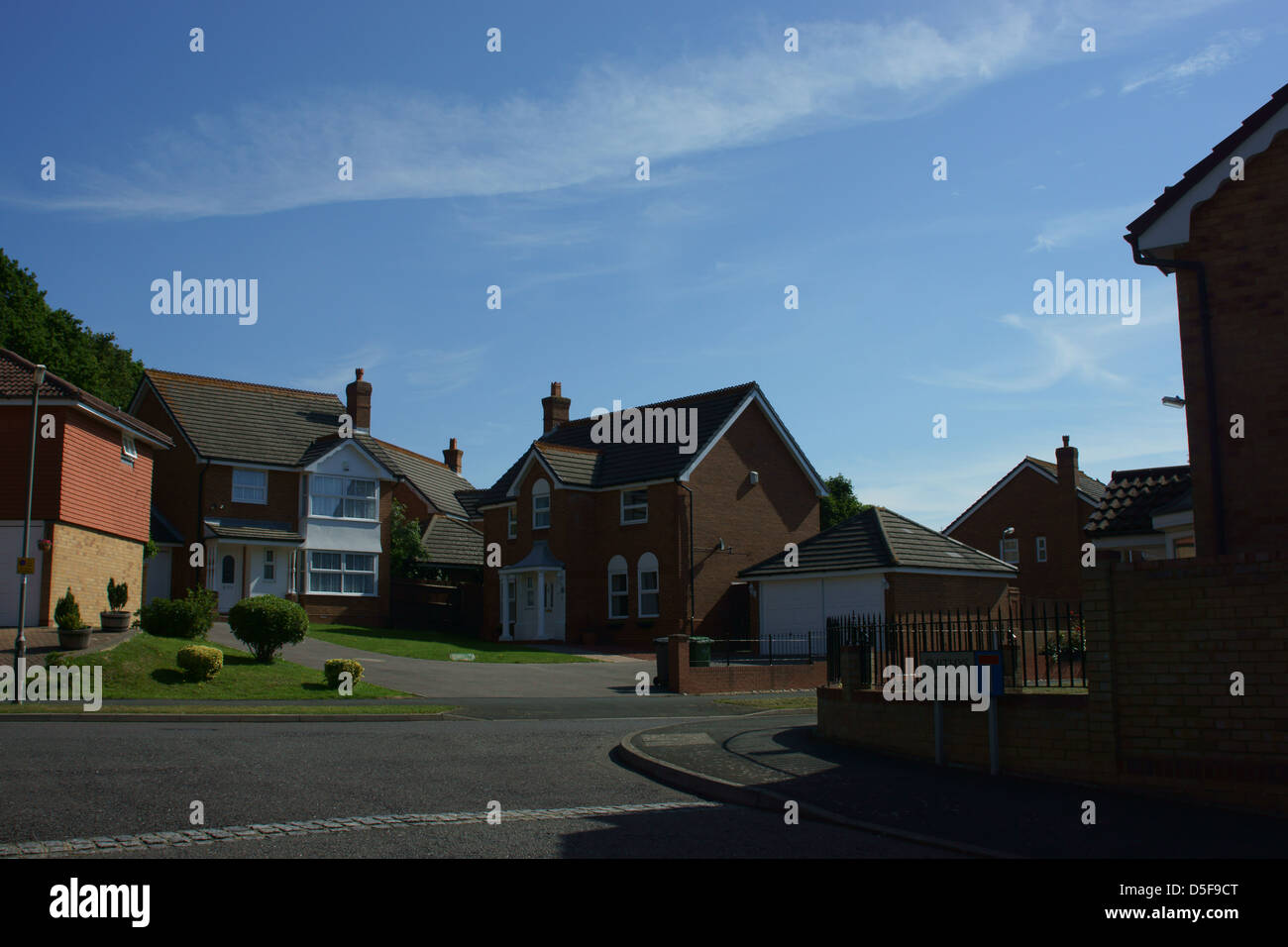 English housing estate blue sky road pavement sign Stock Photo