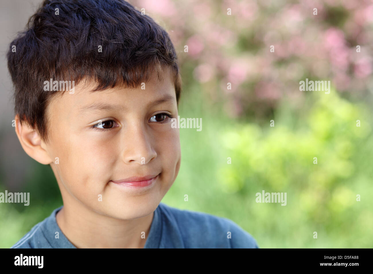 Smiling young boy outside with copy space to right Stock Photo