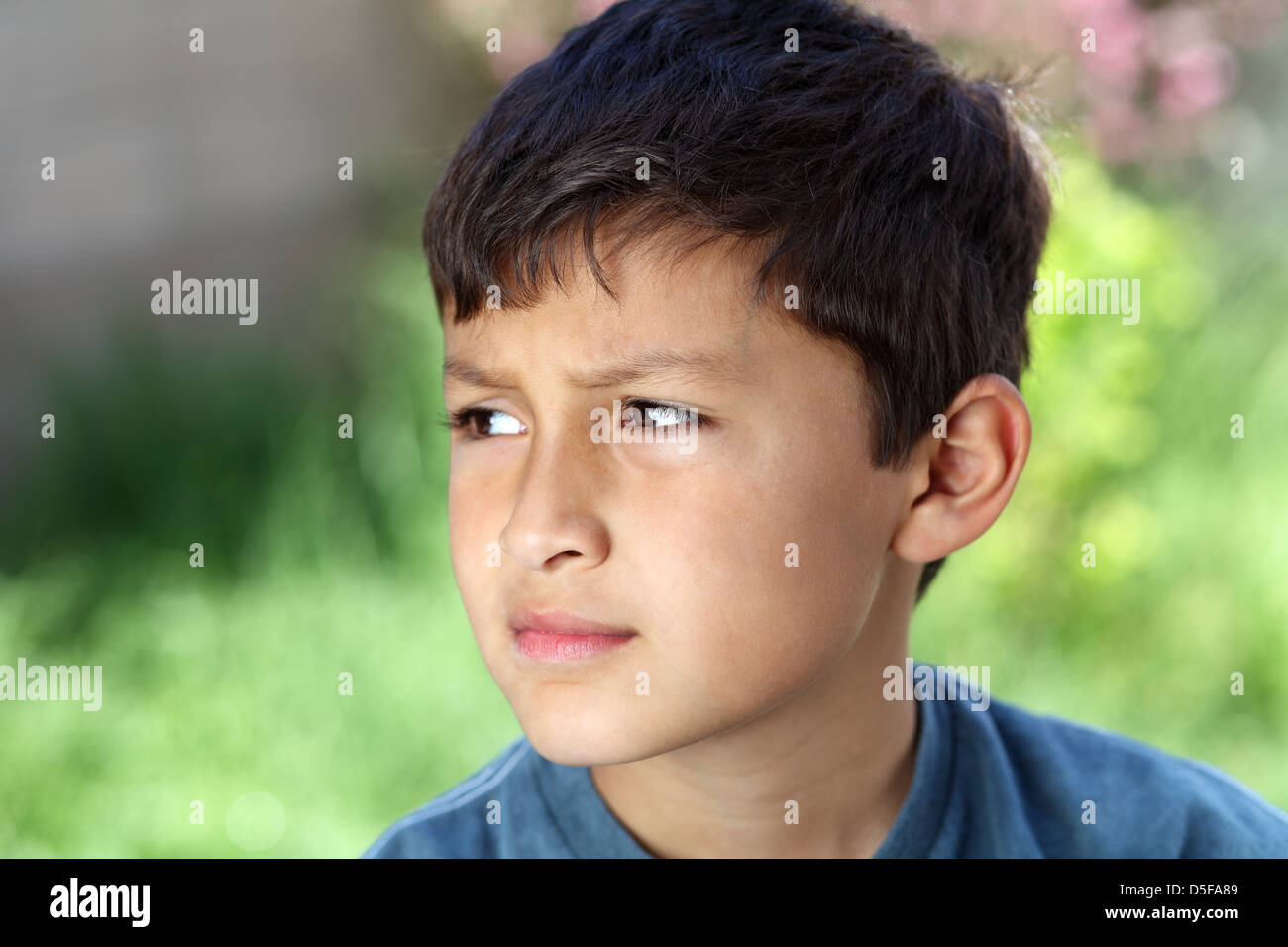 Smiling young boy outside with copy space to left Stock Photo