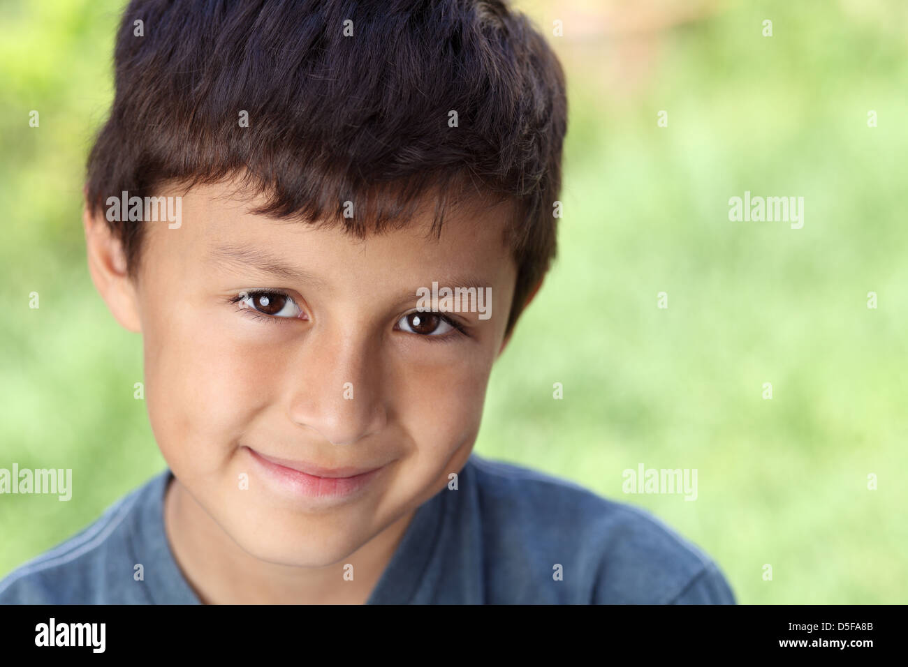 Smiling young boy outside with copy space to right Stock Photo