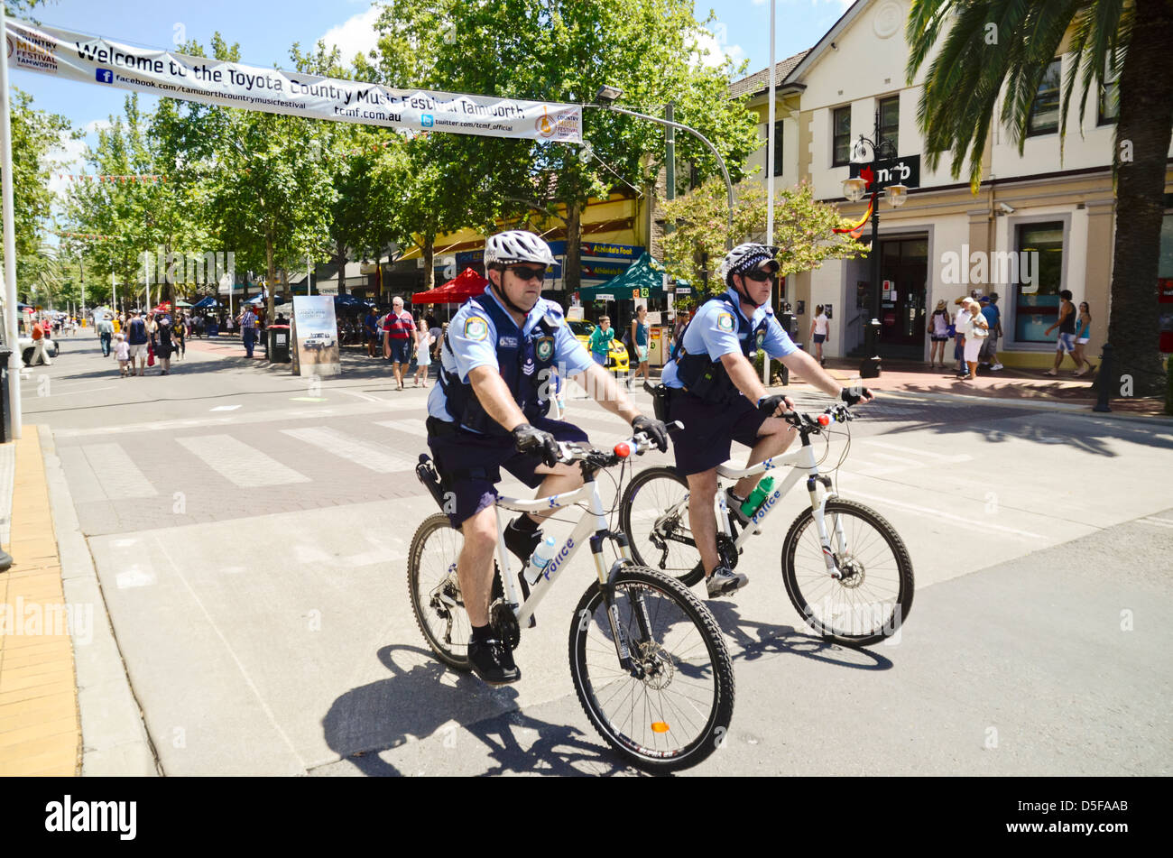 Australian police patrolling street on bicycles Stock Photo