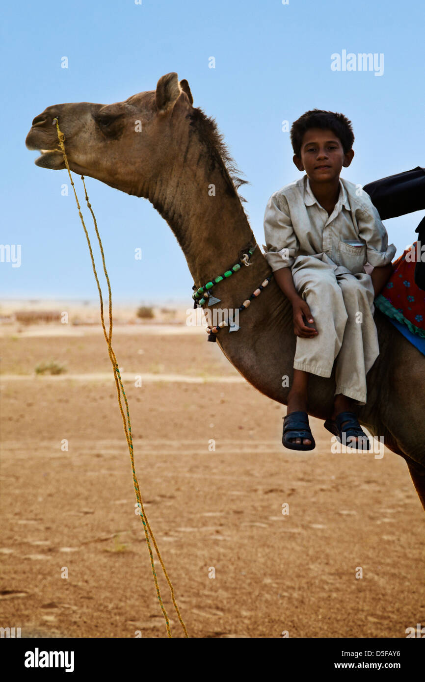 Boy on camel in desert, Jaisalmer, Rajasthan, India Stock Photo - Alamy