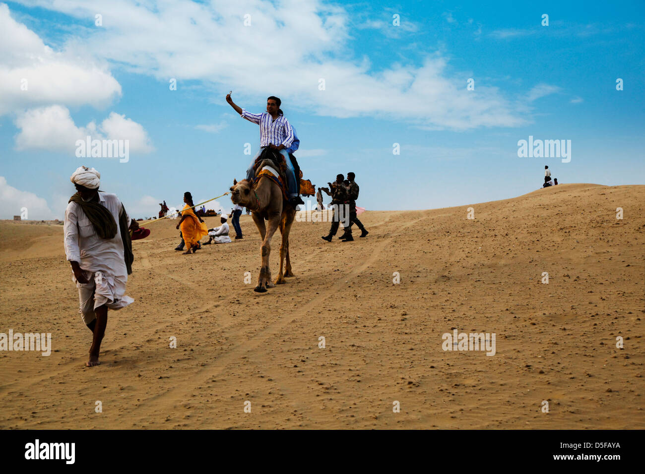 Tourists on a camel safari in desert, Jaisalmer, Rajasthan, India Stock ...