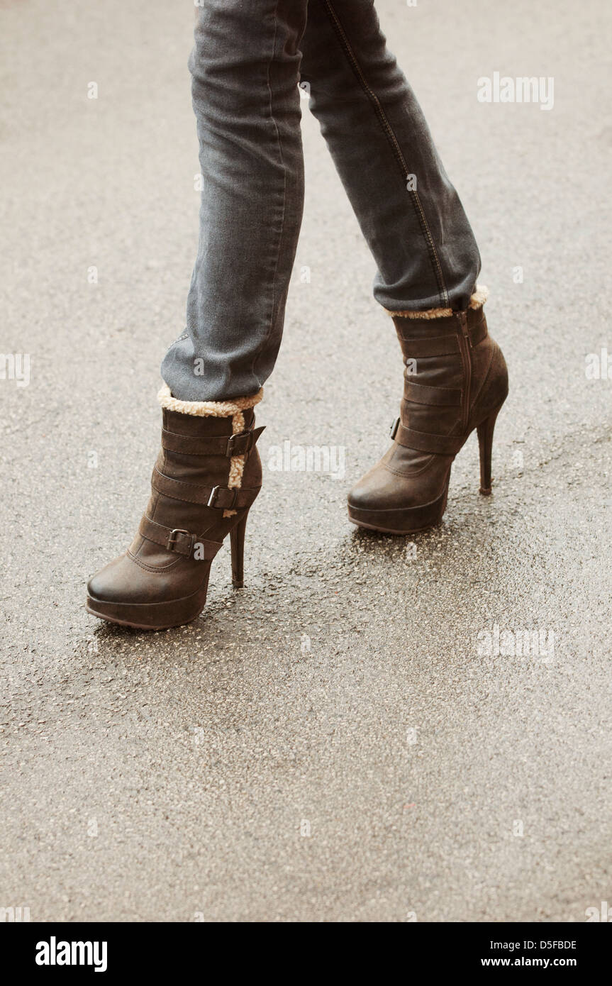 Woman walking in high heels winter boots Stock Photo - Alamy