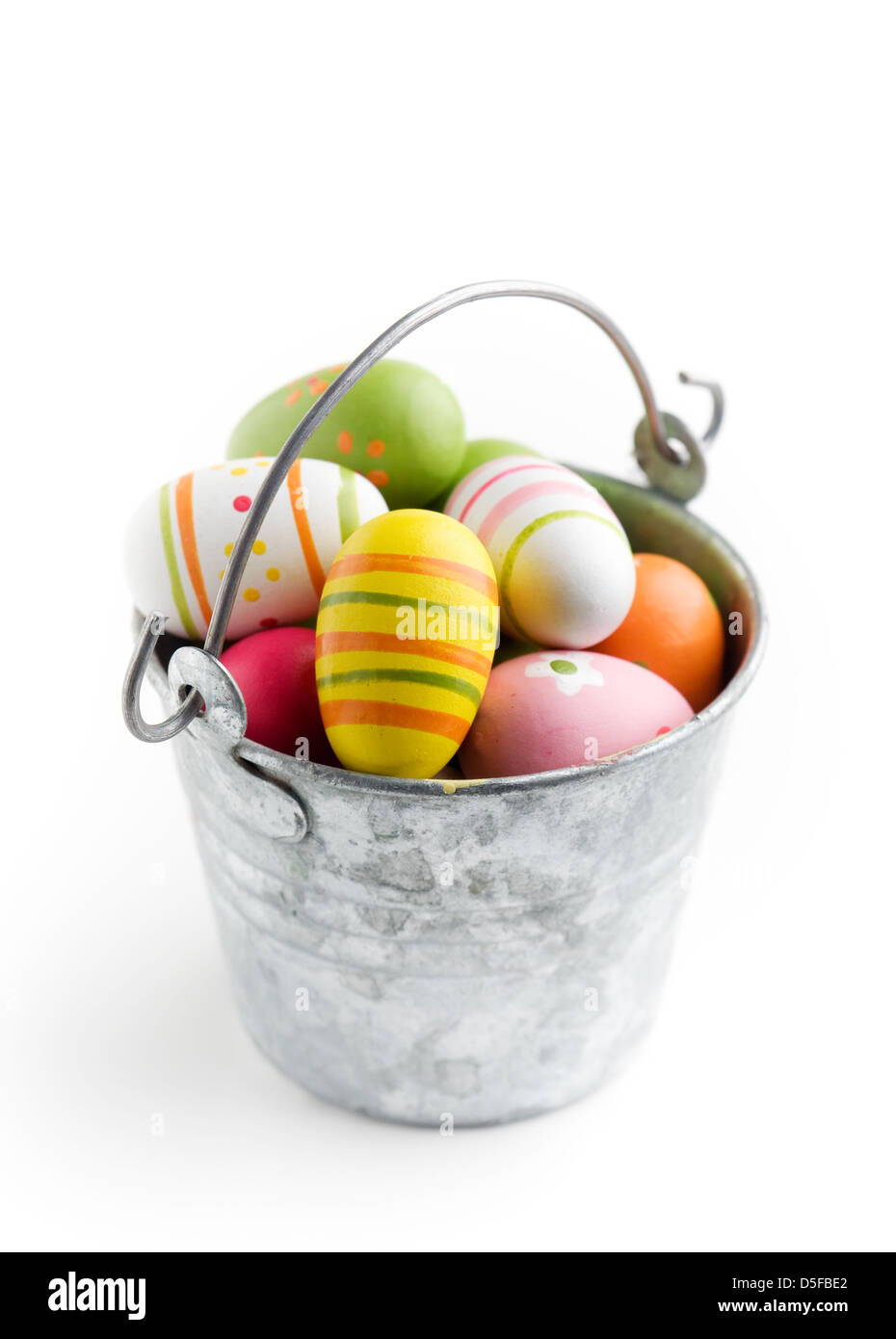 Colorful easter eggs in bucket, isolated on white Stock Photo