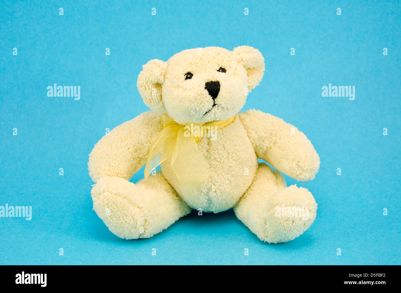 one white polar bear toy on azure background Stock Photo