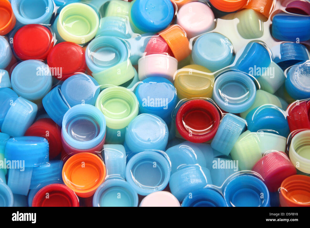 In many colors bottle caps with caps in four colors. Stock Photo