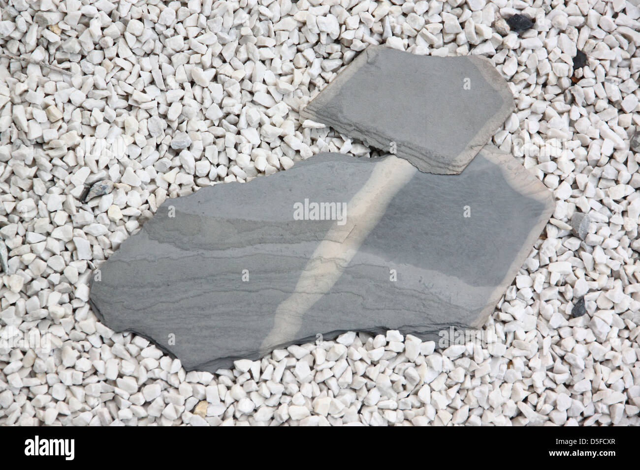 https://c8.alamy.com/comp/D5FCXR/the-large-stone-slabs-on-a-white-small-rock-D5FCXR.jpg