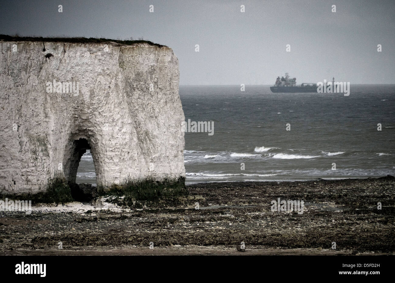 Chalk cliff at Kingsgate Bay Thanet Kent Merchant ship sheltering from a storm. Stock Photo