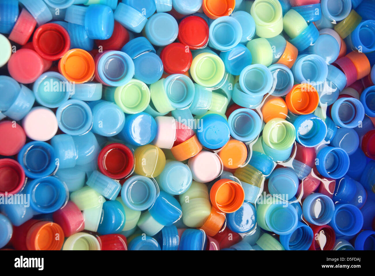 In many colors bottle caps with caps in four colors. Stock Photo