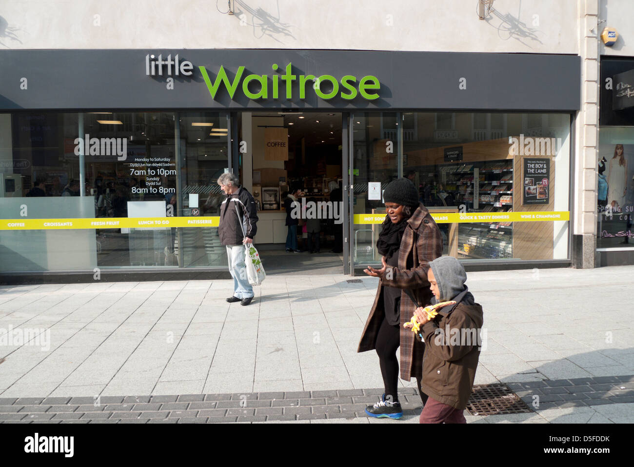 People in front of little Waitrose supermarket store Queen Street Cardiff Wales UK Stock Photo