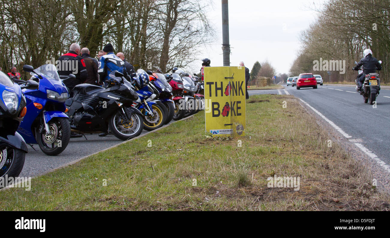 Think bike campaign sign at the roadside near Caton Lancashire with motion blurred traffic Stock Photo
