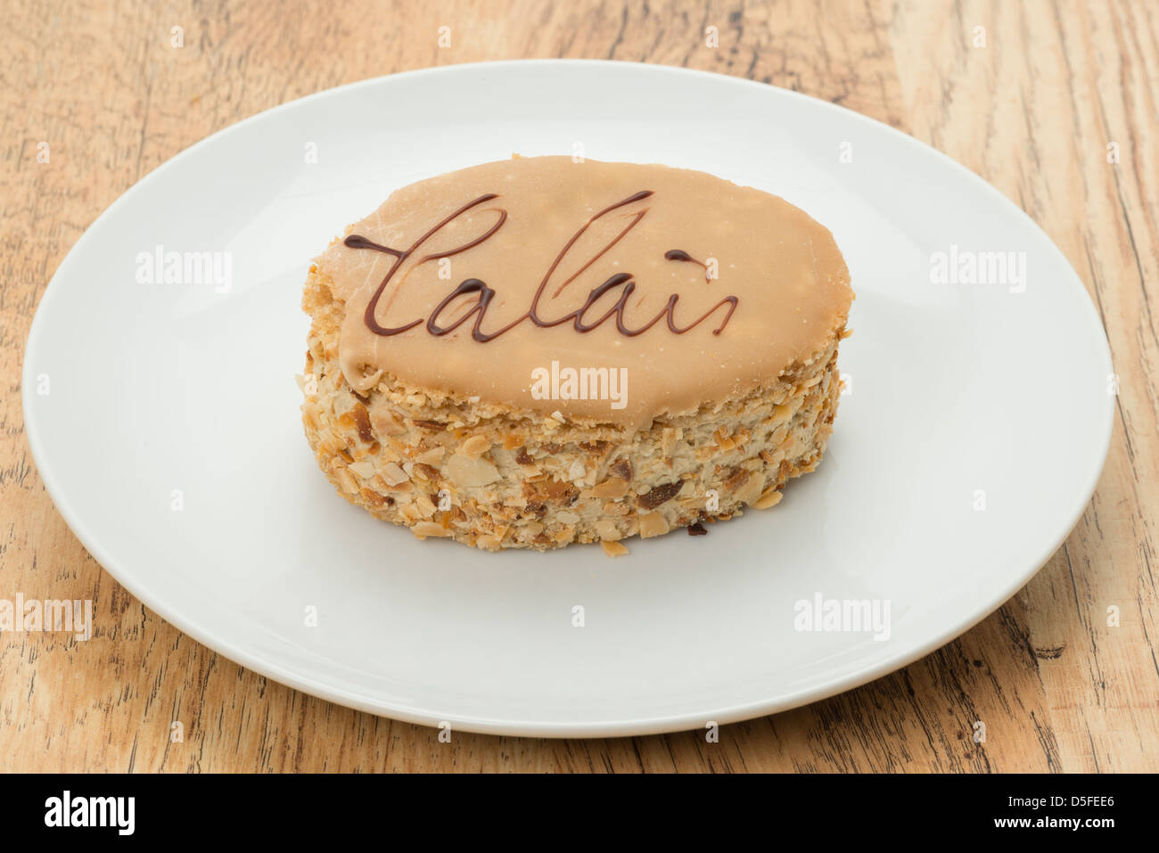 Traditional Calais Cake On A White Plate A Calais Cake Is A Nutty Meringue And Coffee Flavoured Cake From The Pay De Calais Reg Stock Photo Alamy