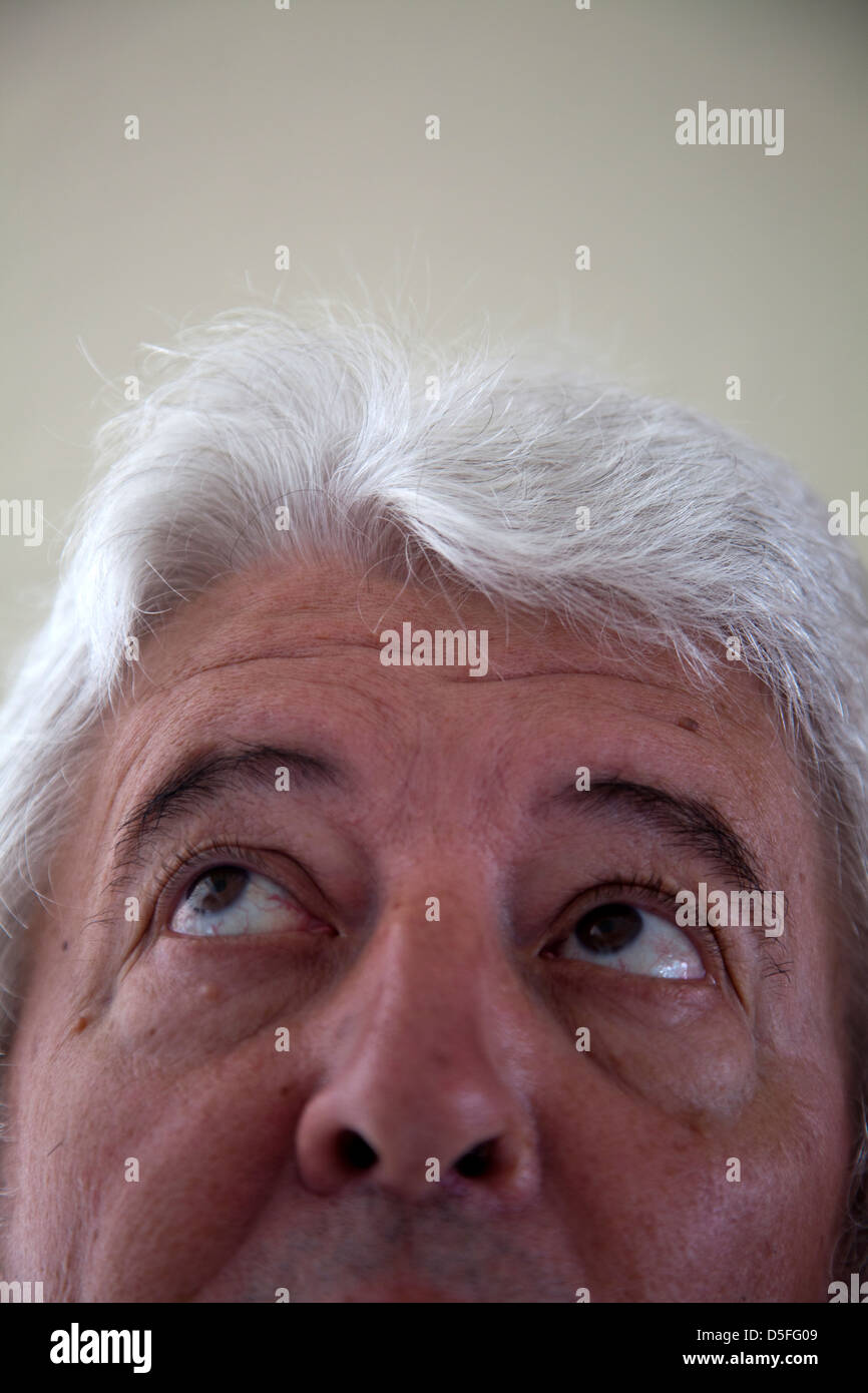 Man With Silver Hair Looking Up Stock Photo