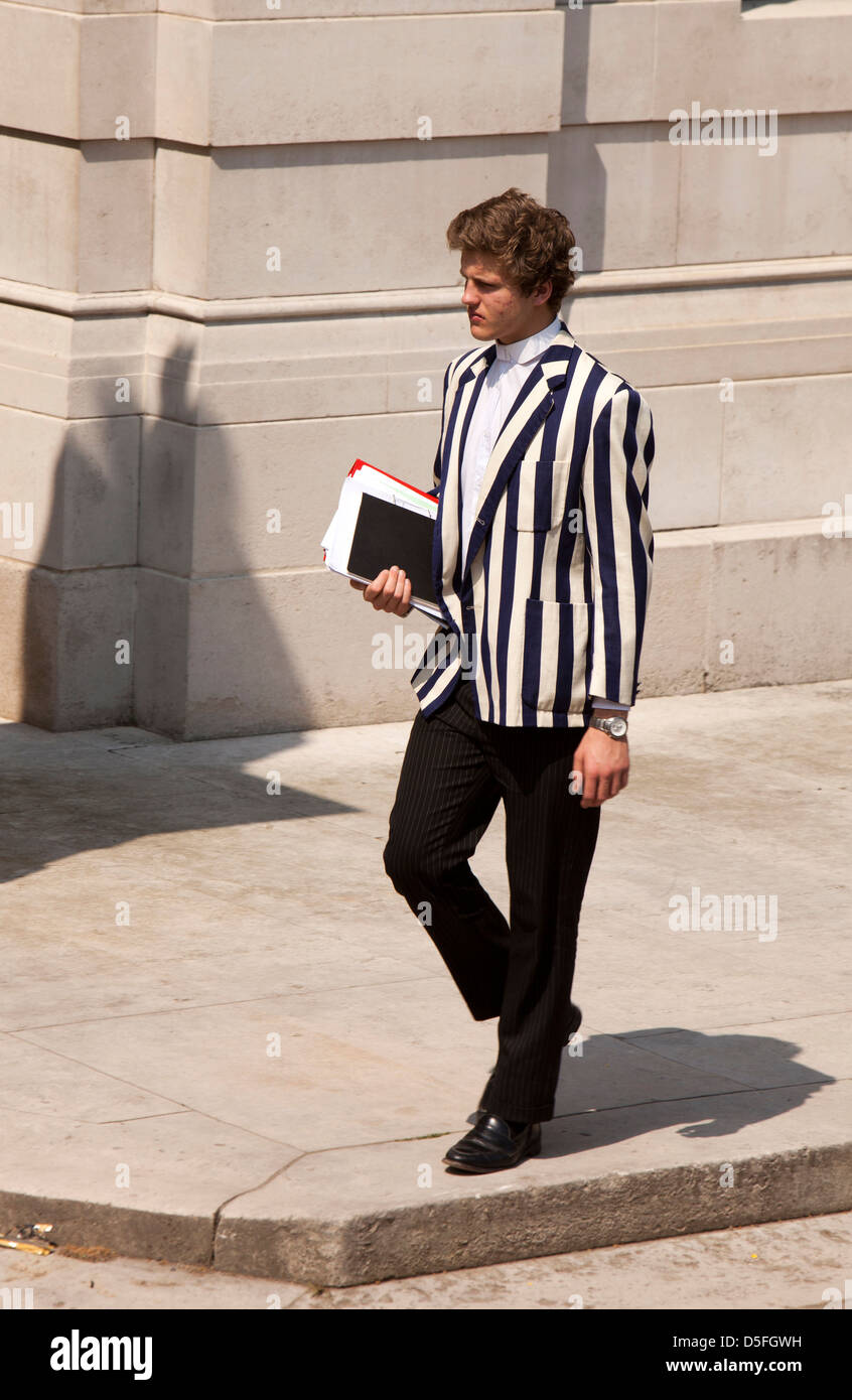 England, Berkshire, Eton College student in rowing blazer outside ...