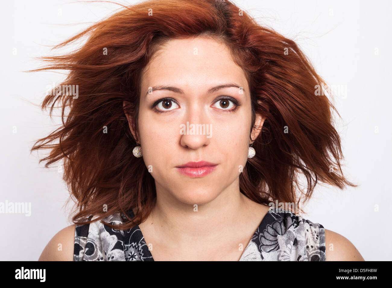 Close up of young woman with thick high volume brown hair Stock Photo