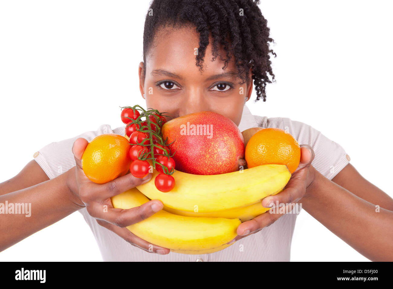 Young happy black / african american woman holding fresh fruits isolated on white background Stock Photo