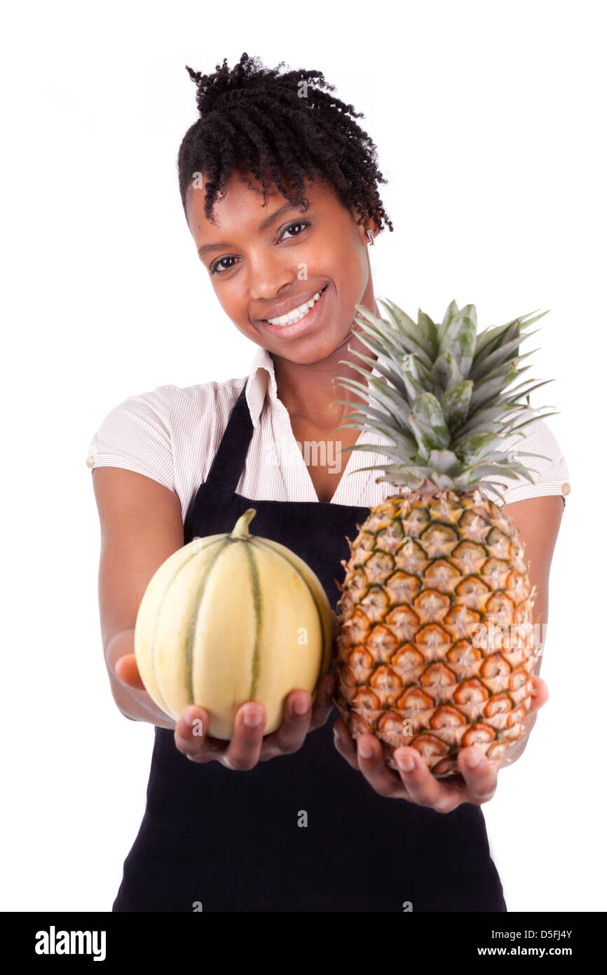 Young happy black / african american woman selling fresh fruits isolated on white background Stock Photo