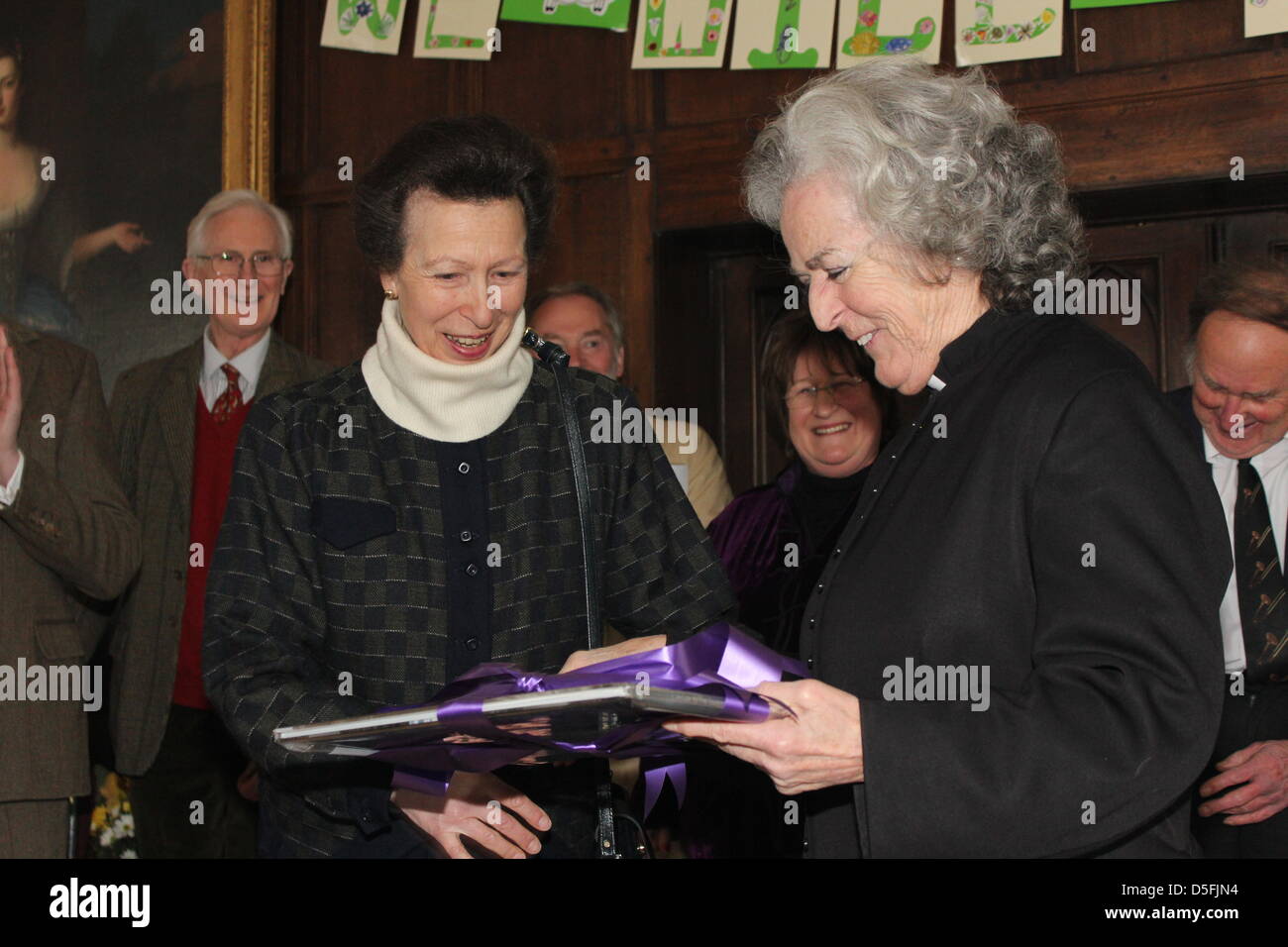 Avening, near Cirencester, Gloucestershire, UK. 31st March 2013.  The Princess Royal Presents a retirement gift to the Rev Celia Carter MBE, at Avening Court, Avening, near Cirencester. Rev Celia has been Priest in charge at Avening since 1984, and was among the first women in England to be pristed - she was awarded an MBE by the Princess Royal in 2012. The Princess Royal is accompanied by her husband Sir Timothy Laurence. The Princess was very relaxed, and after attending the service, took time to mingle and chat with villagers Credit: Antony Slater / Alamy Live News Stock Photo