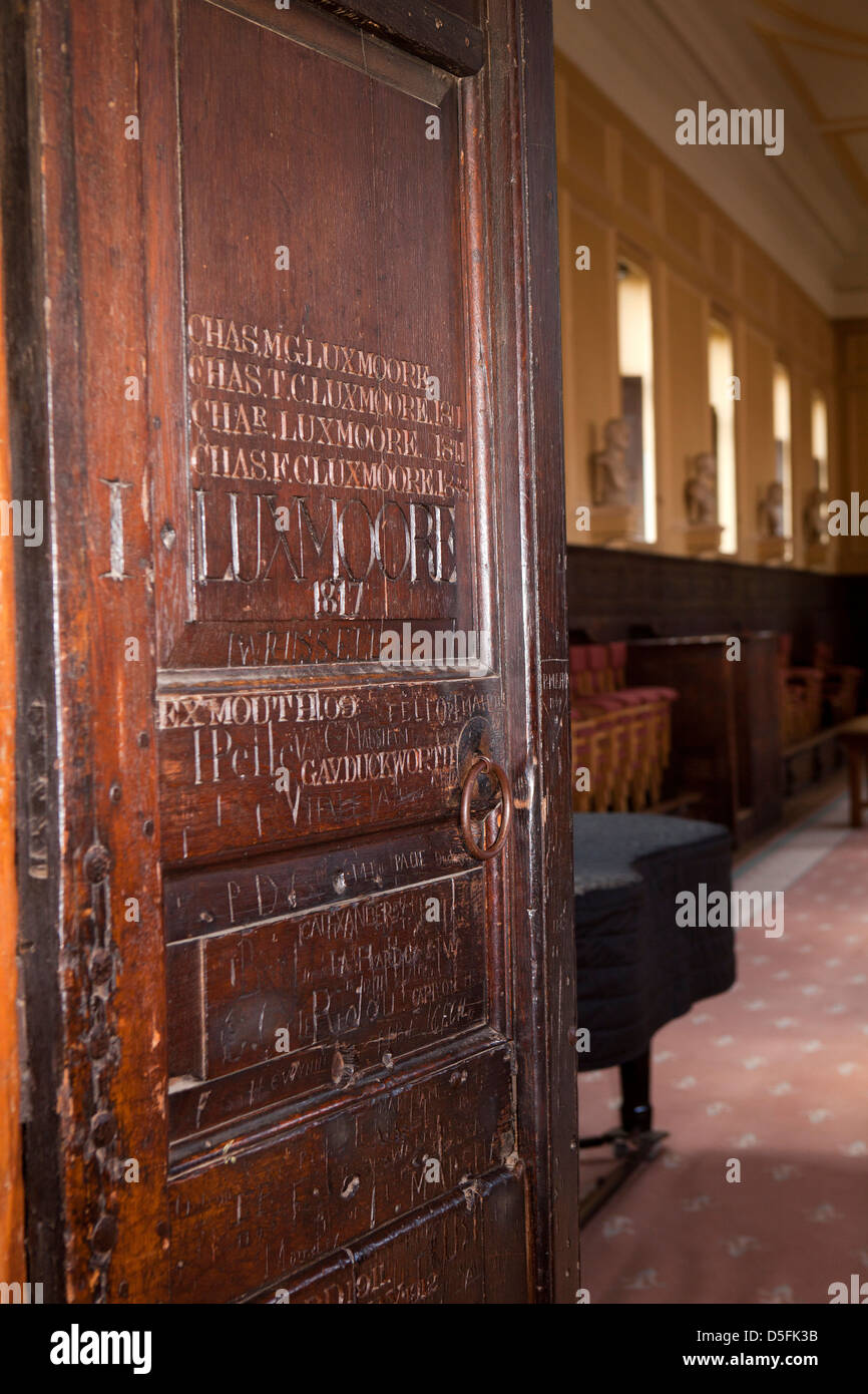 England, Berkshire, Eton College, Upper School, students names carved in wooden door Stock Photo