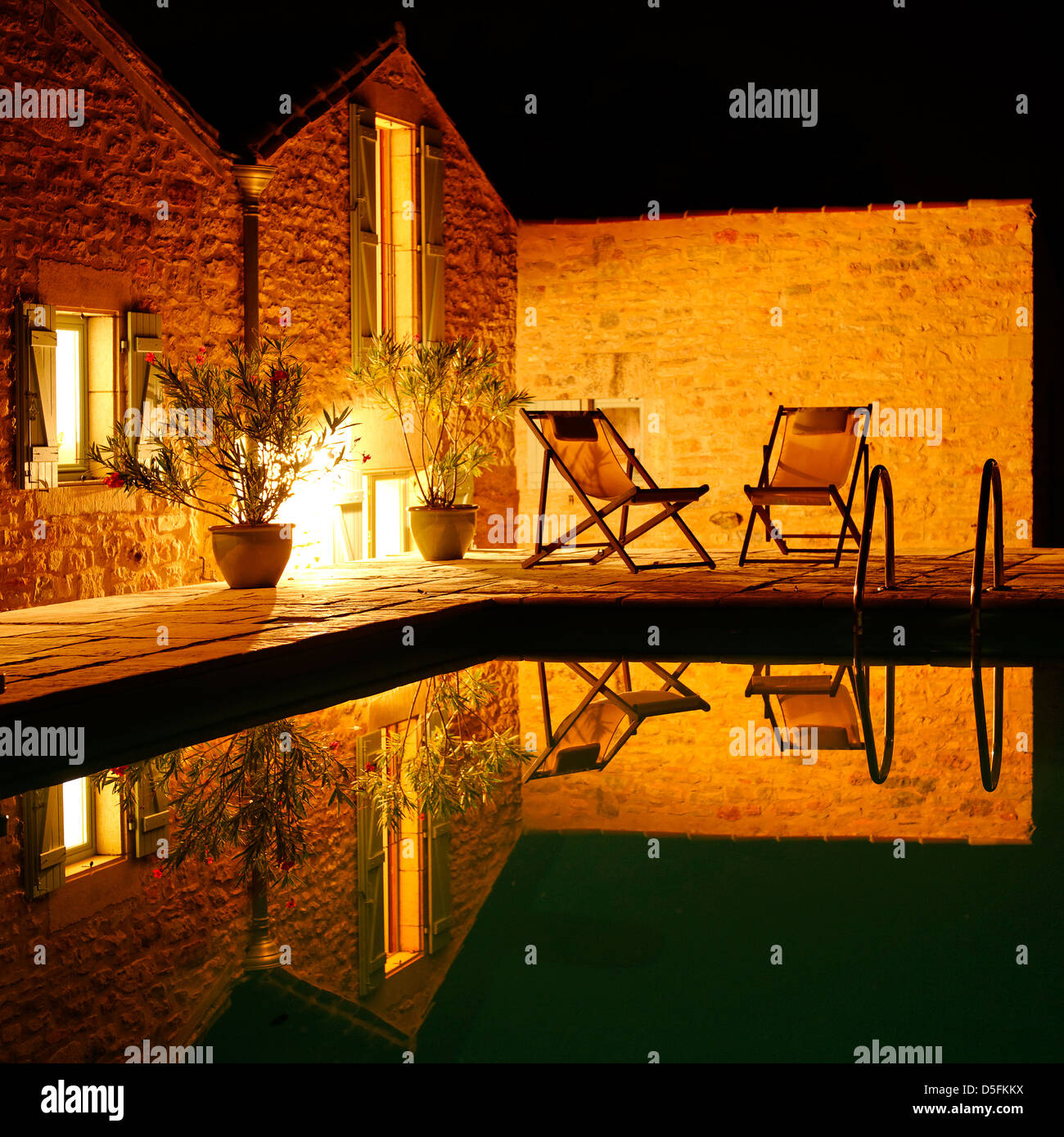 Reflection in a swimming pool at night, France Stock Photo - Alamy