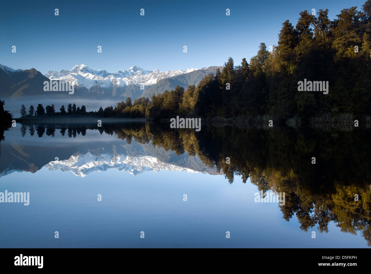 Lake Matheson on a beautiful still morning with Mt Cook and Mt Tasman. South Island, New Zealand. Stock Photo