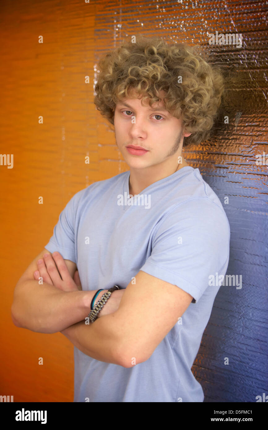 A teenage boy with long curly hair Stock Photo