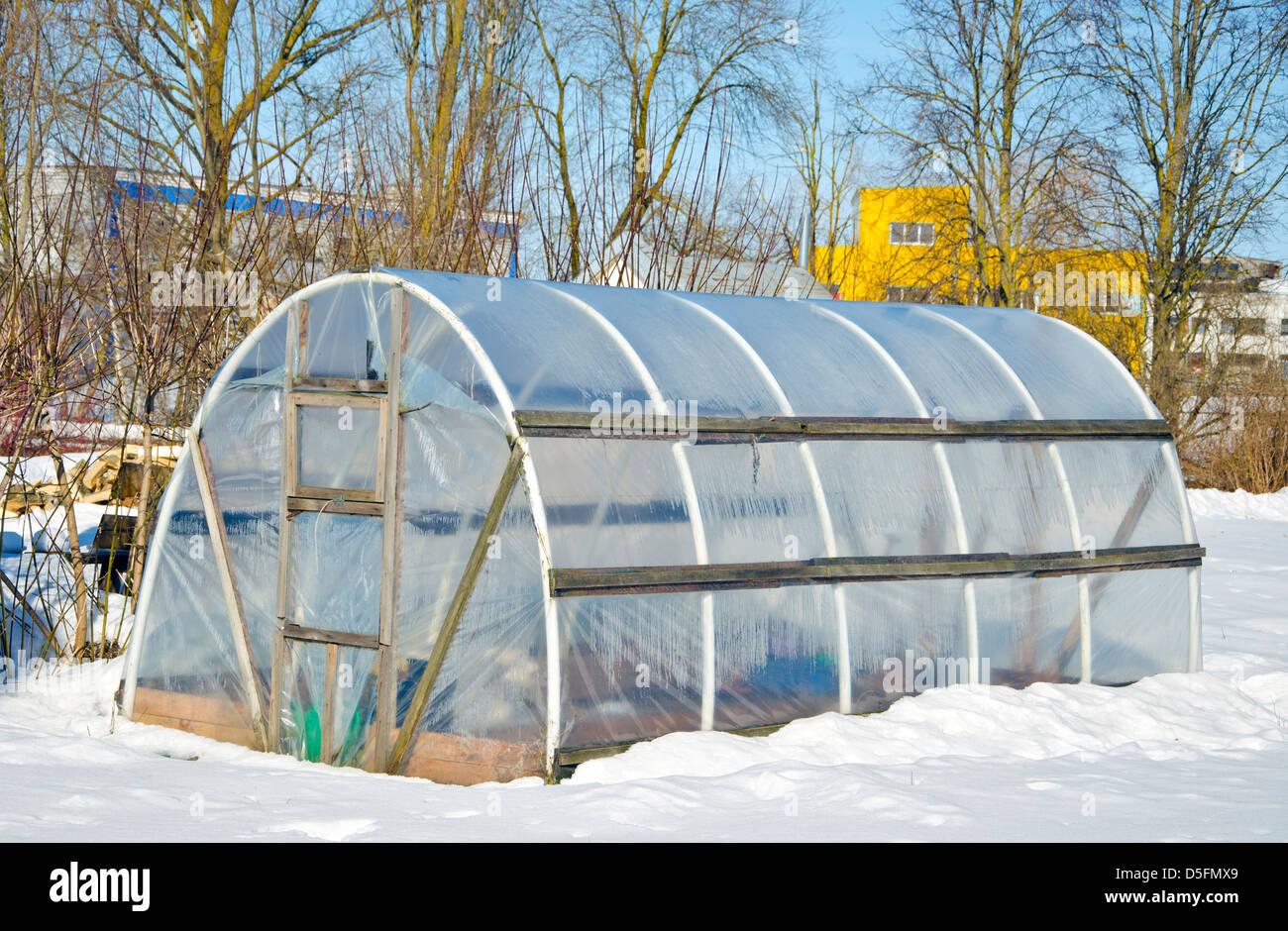 handmade polythene greenhouse for vegetable  in winter time on snow Stock Photo