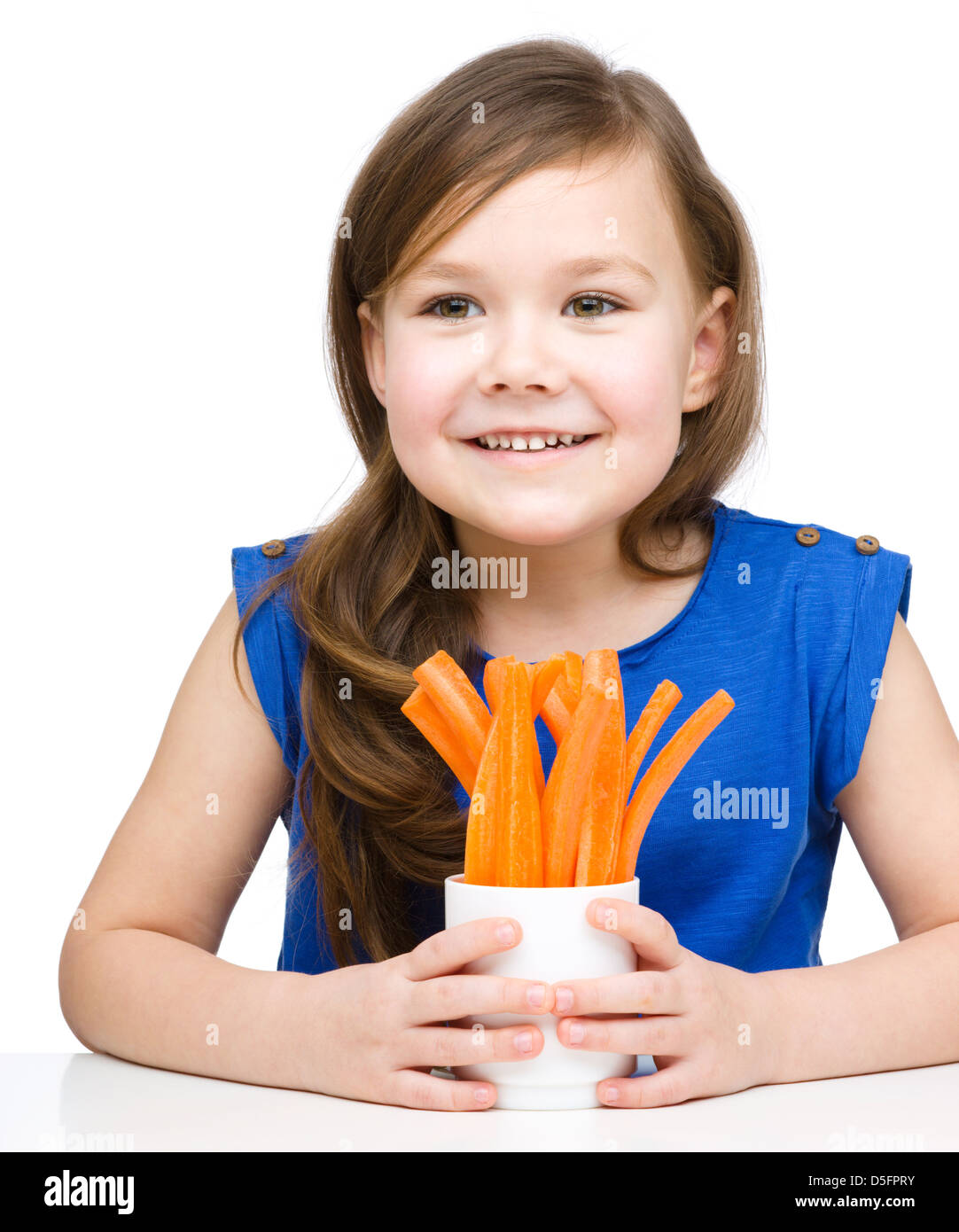 Cute little girl is eating carrot, isolated over white Stock Photo Alamy