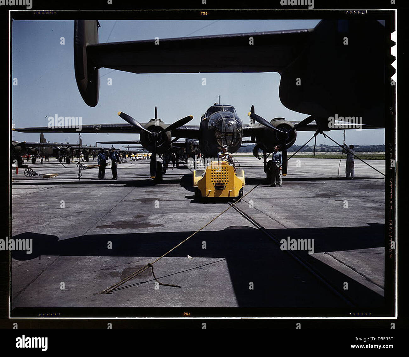 A fast, hard-hitting new A-20 [i.e., B-25] attack bomber is brought for a test hop to the flight line at the Long Beach, Calif., plant of Douglas Aircraft Company (LOC) Stock Photo