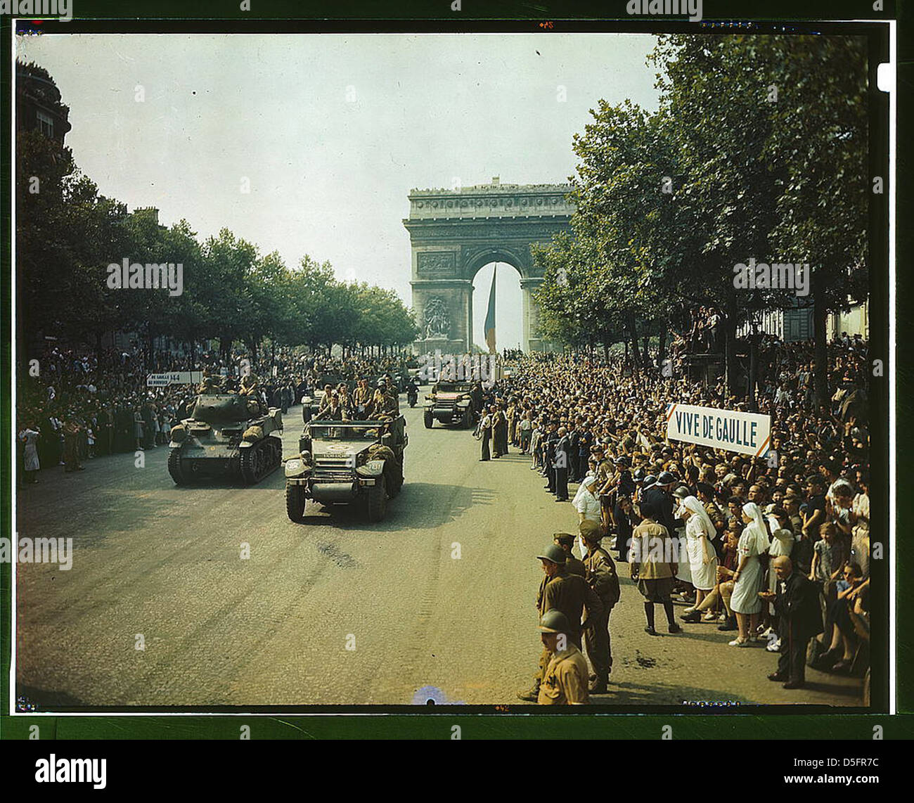 Crowds of French patriots line the Champs Elysees to view Allied tanks and half tracks pass through the Arc du Triomphe, after Paris was liberated on August 25, 1944 (LOC) Stock Photo