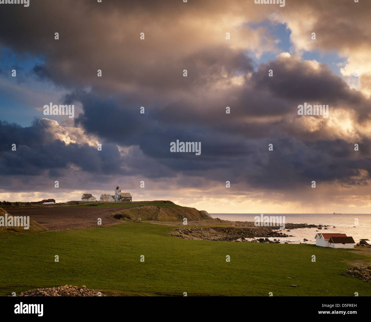 Clouds over Obrestrad fyr at the coast of Jæren, Norway. Stock Photo