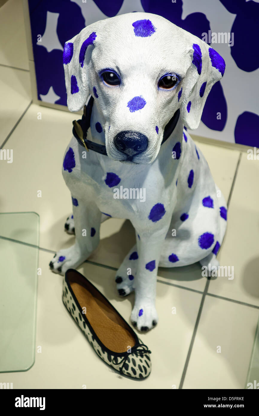 Dalmatian mannequin with slipper in shop window display.  Blue spots. Stock Photo